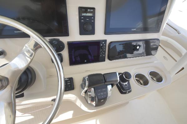 Slide: The Image of Control panel of a 2018 Boston Whaler 330 Outrage boat with modern navigation equipment. - 16