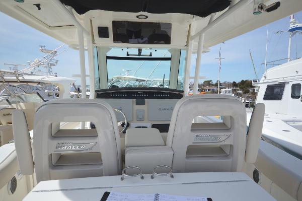 Slide: The Image of 2018 Boston Whaler 330 Outrage boat cockpit with dual seats and control panel. - 27