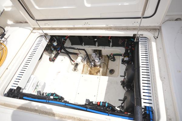 Slide: The Image of 2018 Boston Whaler 330 Outrage engine compartment with visible wiring and components. - 28