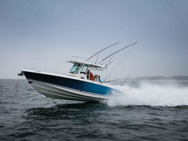 Slide: The Image of 2024 Boston Whaler 330 Outrage speeding on open water. - 38