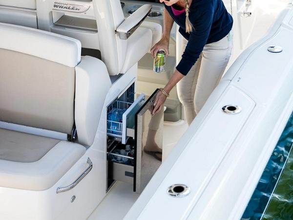 Slide: The Image of 2024 Boston Whaler 330 Outrage boat interior with built-in cooler and seating. - 40