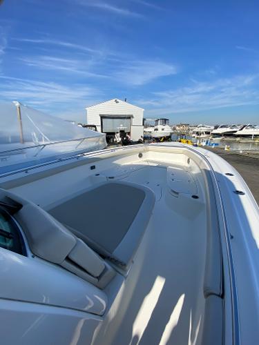 Slide: The Image of 2017 Boston Whaler 350 Outrage boat docked under clear blue sky. - 23