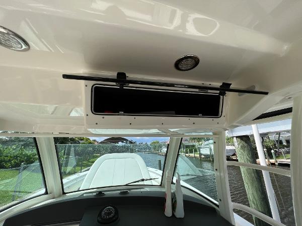 Slide: The Image of Interior view of 2013 Boston Whaler 370 Outrage boat cockpit with open storage compartment. - 17