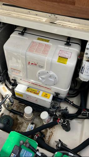 Slide: The Image of 2013 Boston Whaler 370 Outrage engine compartment with generator and wiring. - 19