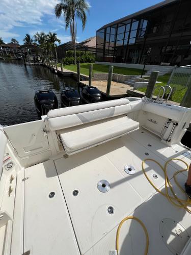 Slide: The Image of 2013 Boston Whaler 370 Outrage boat docked by waterfront homes. - 9