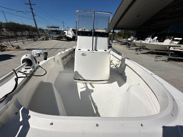 Slide: The Image of 2000 Boston Whaler Outrage 18 boat, white interior, docked outdoors. - 11
