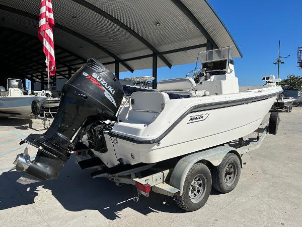 Slide: The Image of 2000 Boston Whaler Outrage 18 boat on trailer with Suzuki outboard motor. - 2