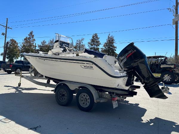 Slide: The Image of 2000 Boston Whaler Outrage 18 boat on trailer, parked outdoors. - 4