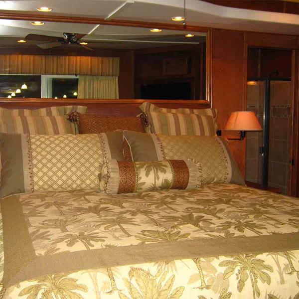 Slide: The Image of Luxurious bedroom interior in a 2011 Bravada Dream Weaver Trip 15 RV. - 8