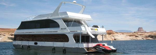Slide: The Image of Bravada Helios Trip #8 houseboat on a lake, 2012 model, with jet ski attached. - 1