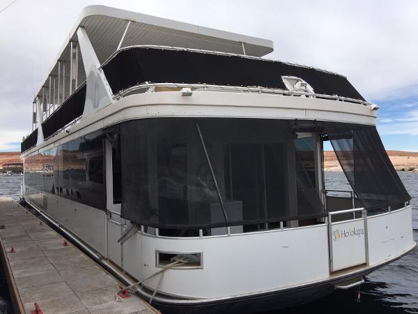 Slide: The Image of 2012 Bravada Ho'okipa Trip 13 houseboat docked on a calm lake. - 0