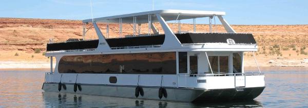 Slide: The Image of Bravada Ho'okipa Trip 13 houseboat, 2012 model, on calm water with desert backdrop. - 1