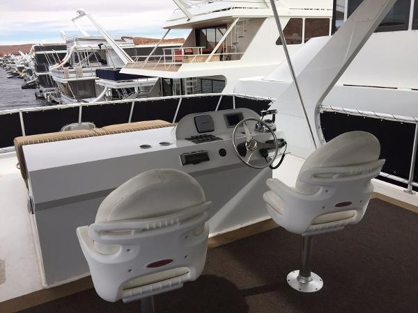 Slide: The Image of Helm of 2012 Bravada Ho'okipa Trip 13 houseboat with dual white captain chairs. - 9