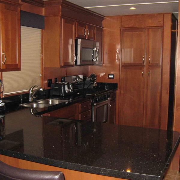 Slide: The Image of Luxurious kitchen in 2010 Bravada Houseboat Dream Catcher, featuring wood cabinetry and modern appliances. - 3