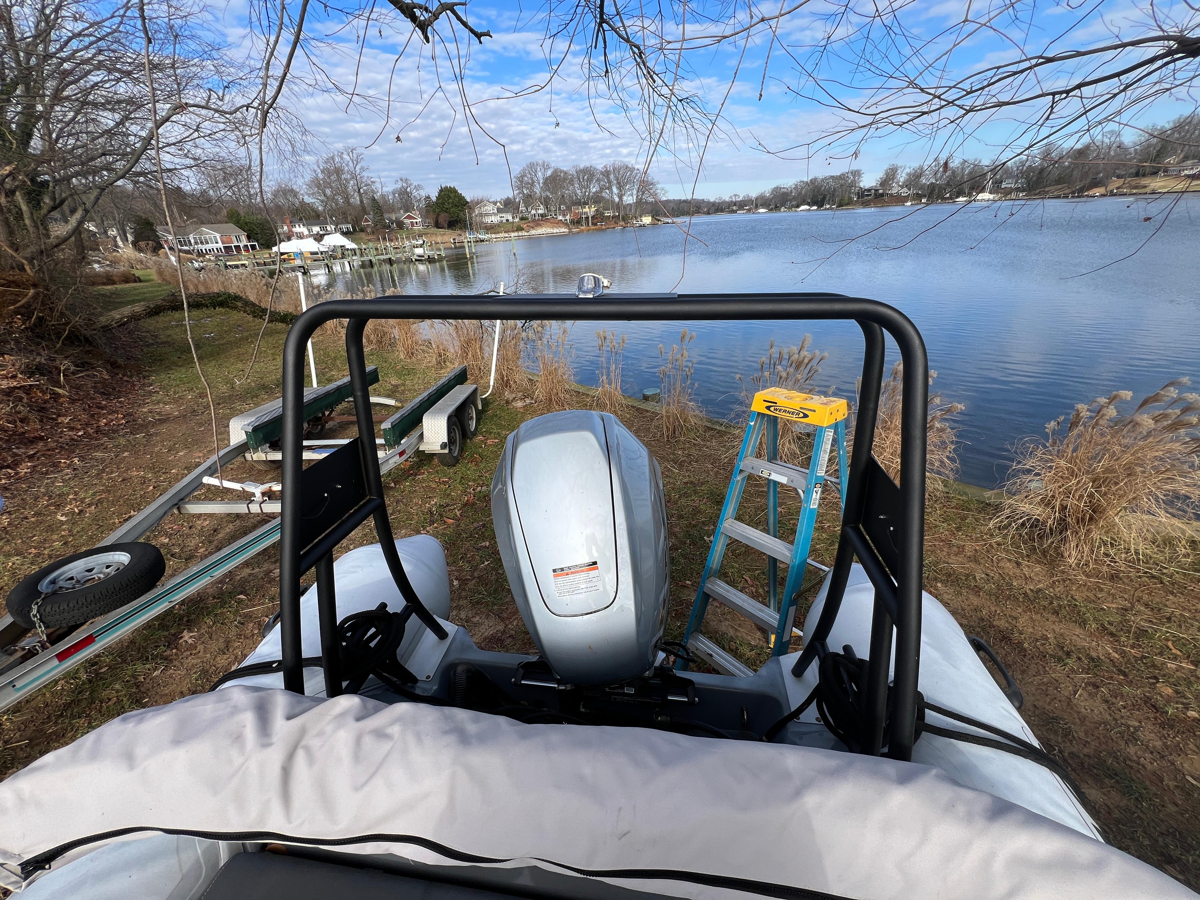 Slide: The Image of Brig Inflatables Navigator 520 (2021) by a lakeside with a boat trailer and ladder. - 10