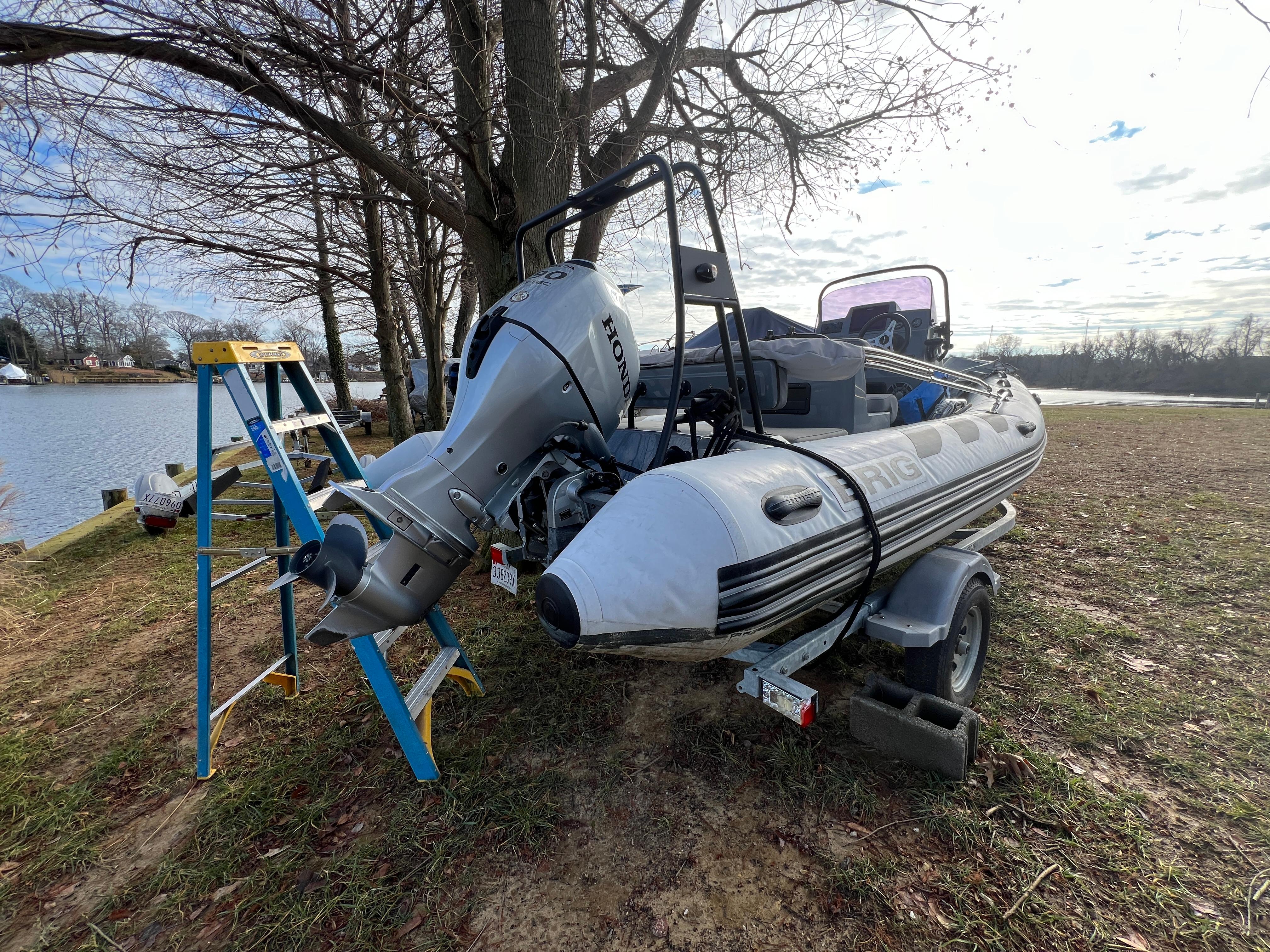 Slide: The Image of 2021 Brig Inflatables Navigator 520 boat on trailer by lakeside with Honda outboard motor. - 15