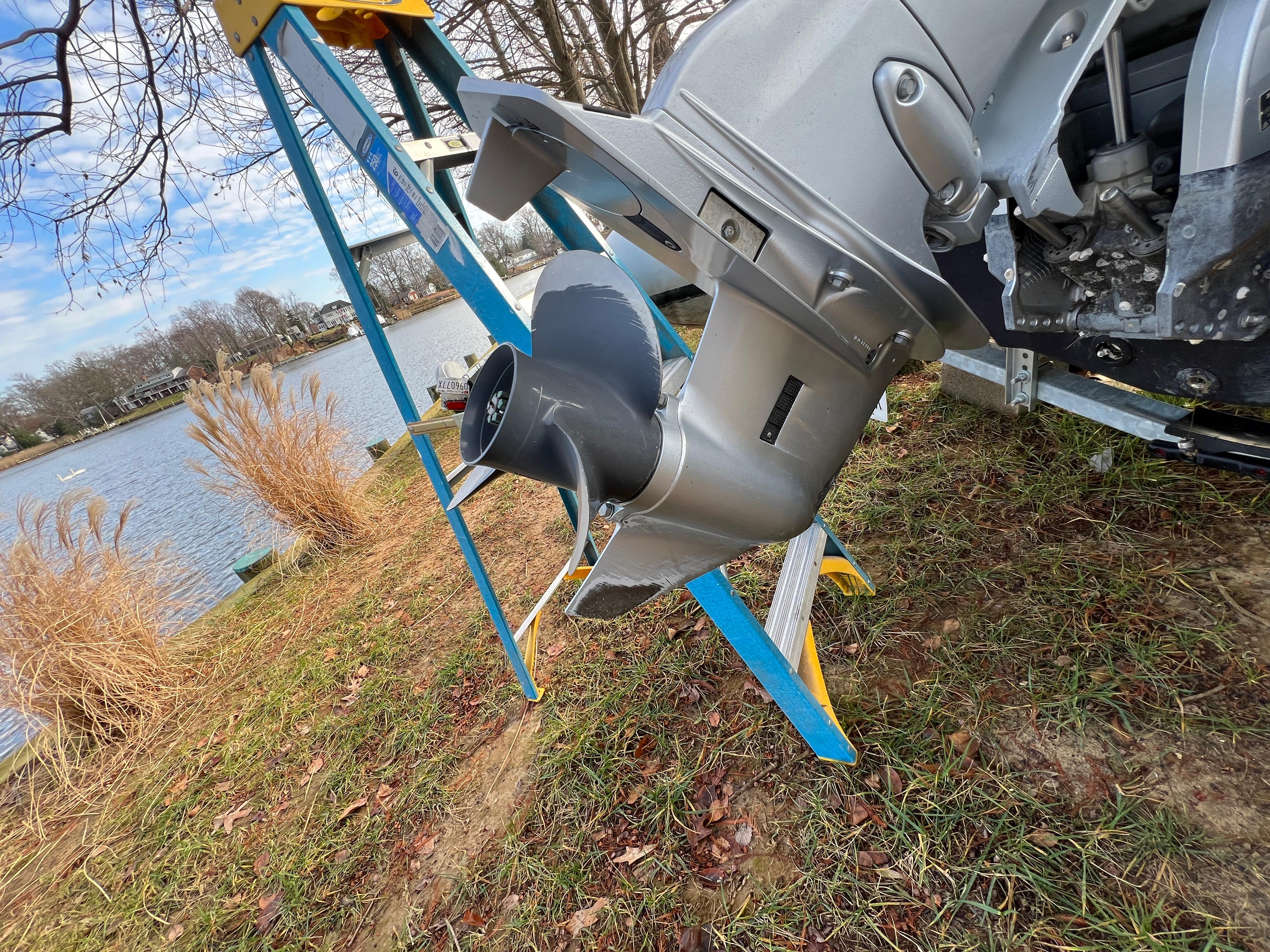 Slide: The Image of Close-up of a 2021 Brig Inflatables Navigator 520 outboard motor by a lakeside. - 17