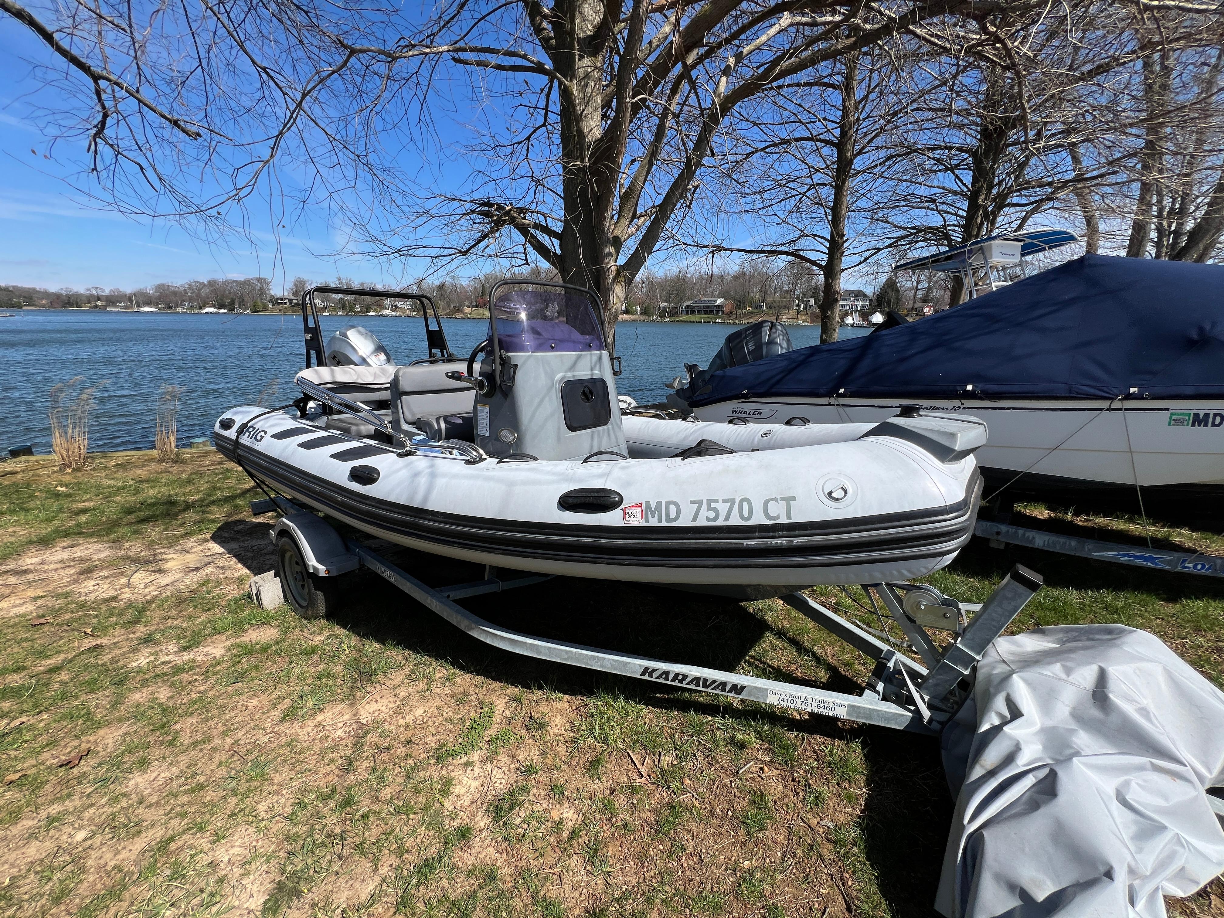 Slide: The Image of 2021 Brig Inflatables Navigator 520 boat on trailer by a lake. - 23