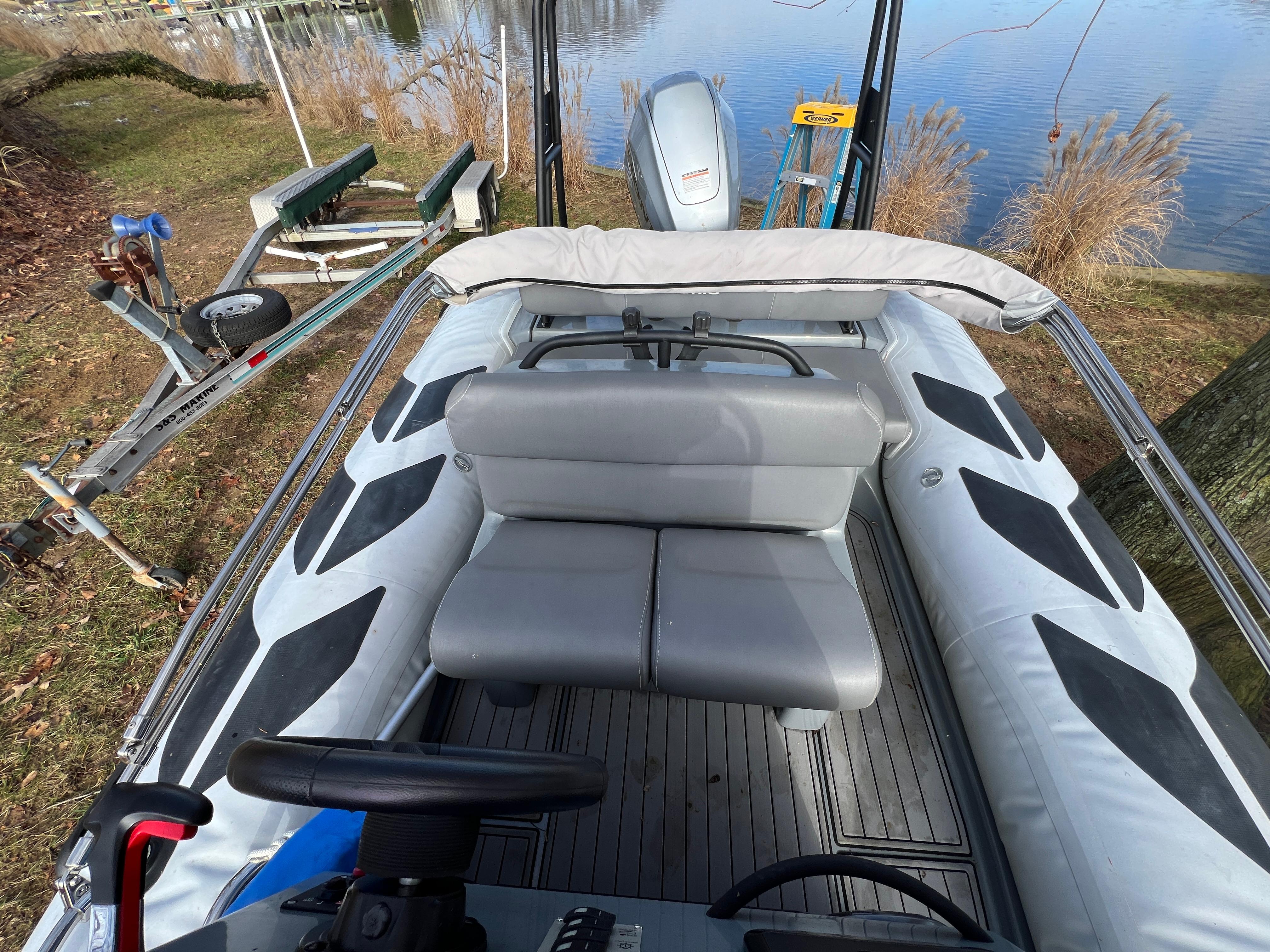 Slide: The Image of 2021 Brig Inflatables Navigator 520 boat on trailer by a lake. - 3