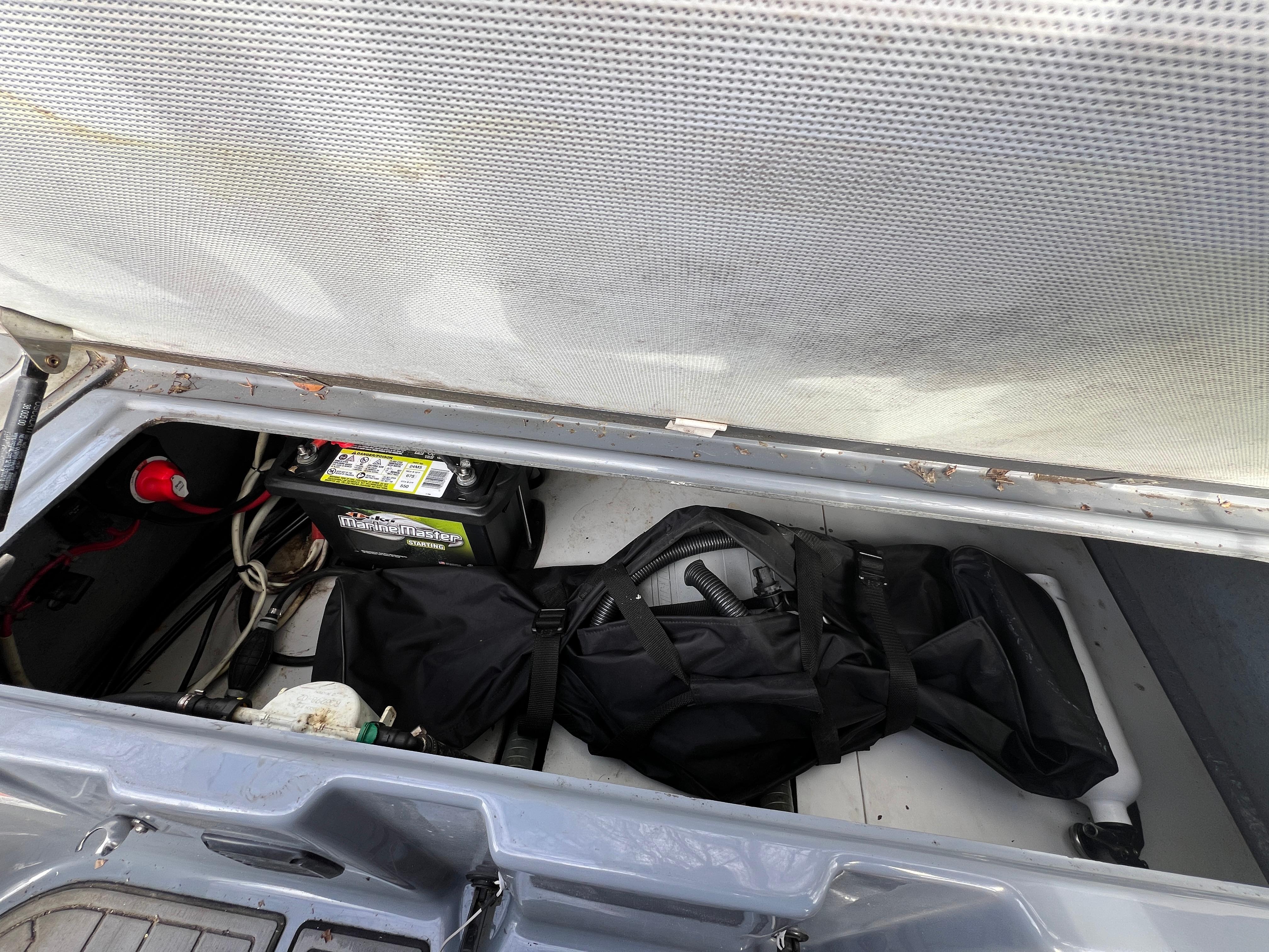 Slide: The Image of Storage compartment of a 2021 Brig Inflatables Navigator 520 boat with marine battery. - 4