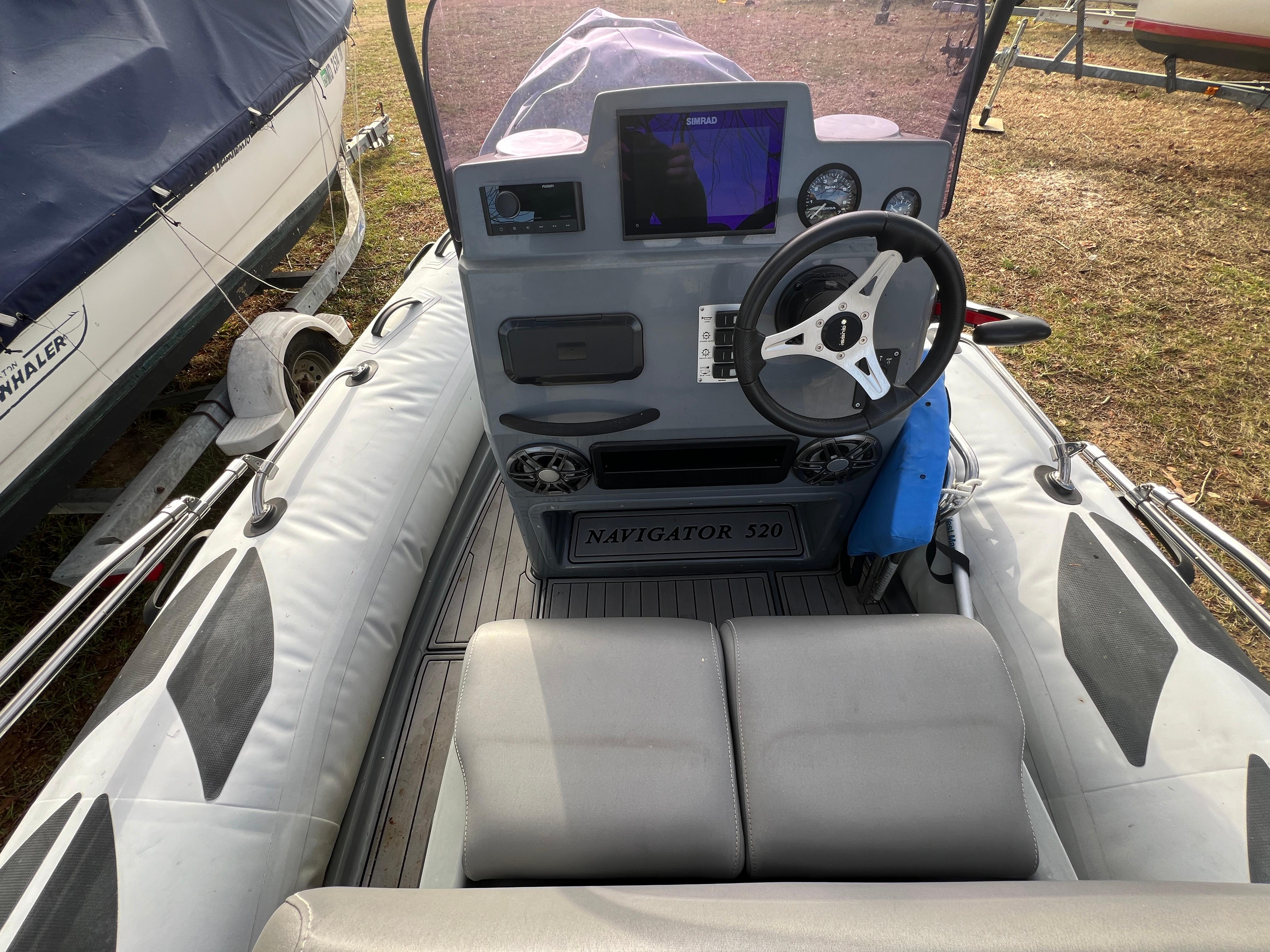Slide: The Image of 2021 Brig Inflatables Navigator 520 boat interior with steering console and seating. - 6