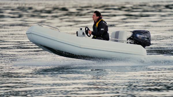 Slide: The Image of Man driving 2024 Bullfrog Yacht Tender 10' on water. - 1