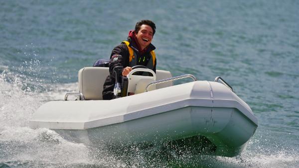 Slide: The Image of Man driving 2024 Bullfrog Yacht Tender 10' on water. - 2