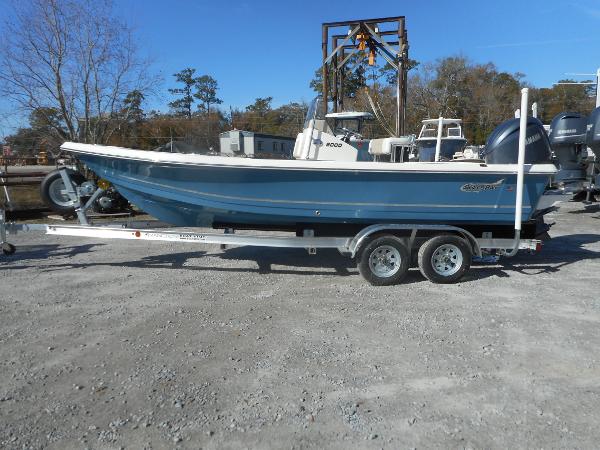 Slide: The Image of 2024 Bulls Bay 2000 boat on a trailer in a gravel lot. - 1