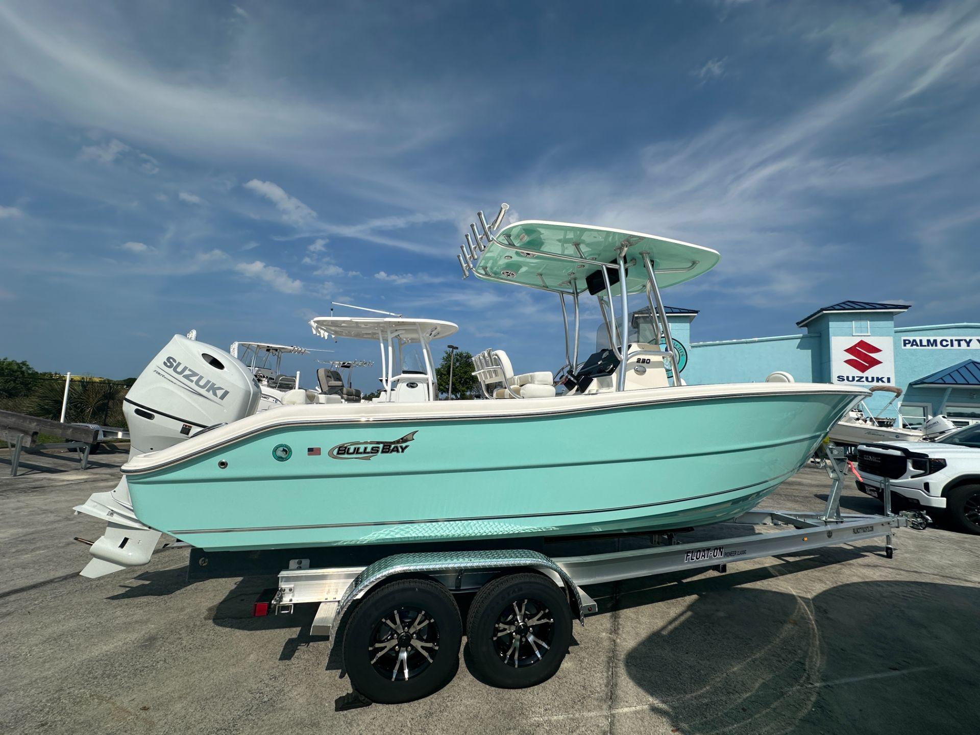 Slide: The Image of 2024 Bulls Bay 230CC boat on trailer with Suzuki outboard motor. - 1