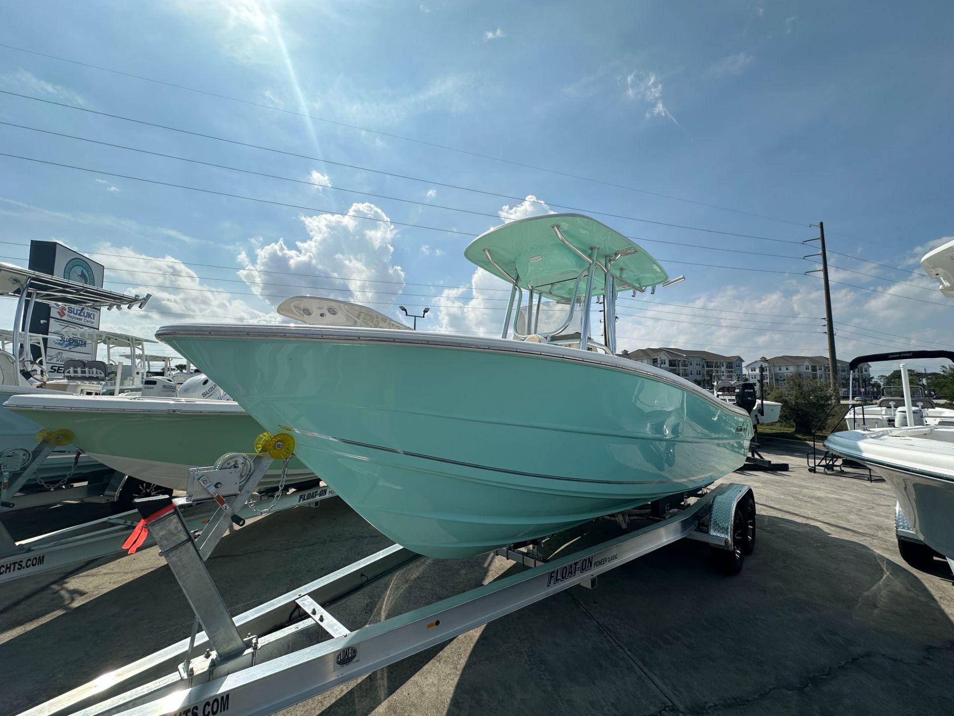 Slide: The Image of 2024 Bulls Bay 230CC boat on trailer under a sunny sky. - 2
