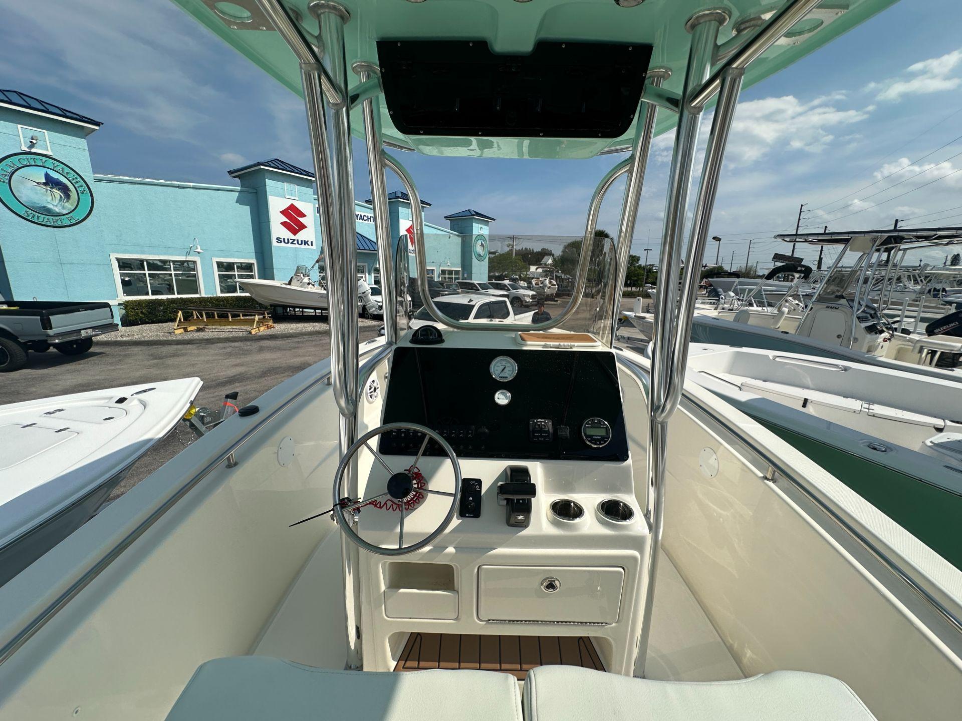 Slide: The Image of 2024 Bulls Bay 230CC center console boat at a dealership. - 4