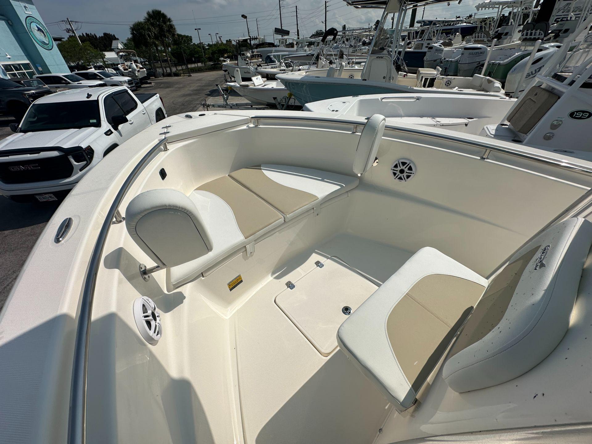 Slide: The Image of 2024 Bulls Bay 230CC boat interior with seating and storage compartments. - 5