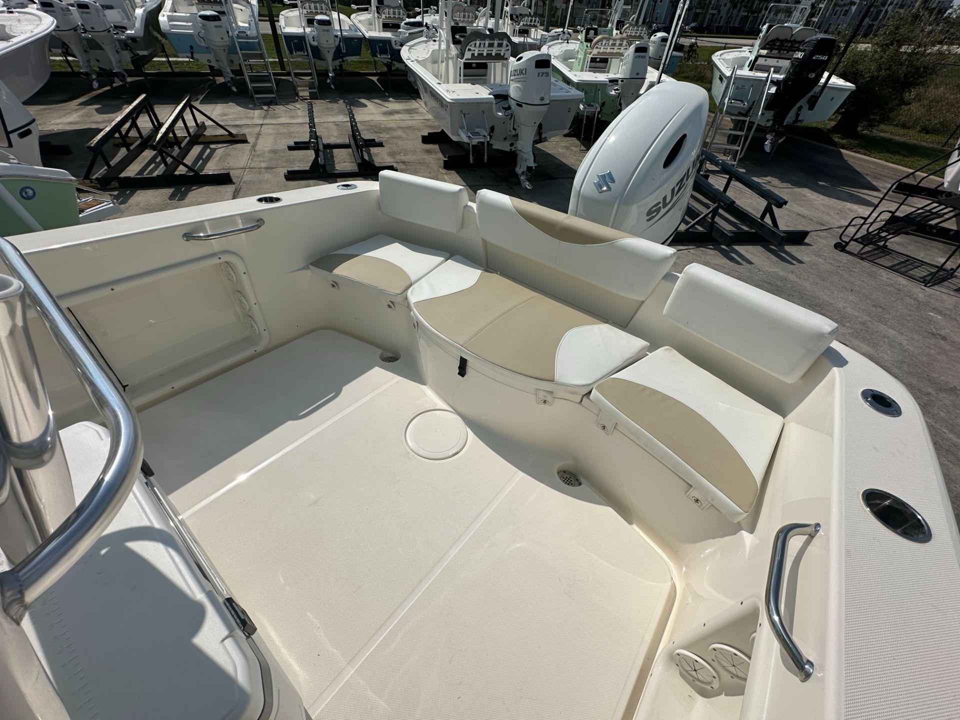 Slide: The Image of 2024 Bulls Bay 230CC boat interior with seating and Suzuki outboard motor. - 8