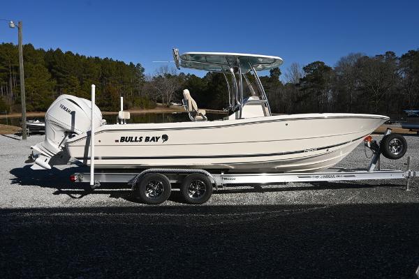Slide: The Image of 2025 Bulls Bay 255CC boat on trailer, side view, outdoors, clear sky. - 0
