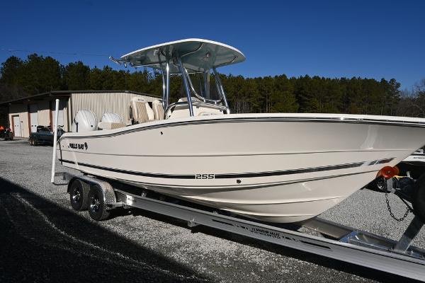 Slide: The Image of 2025 Bulls Bay 255CC boat on trailer, parked outdoors under clear blue sky. - 1