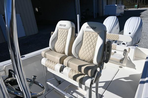Slide: The Image of 2025 Bulls Bay 255CC boat interior with dual cushioned seats and steering wheel. - 10