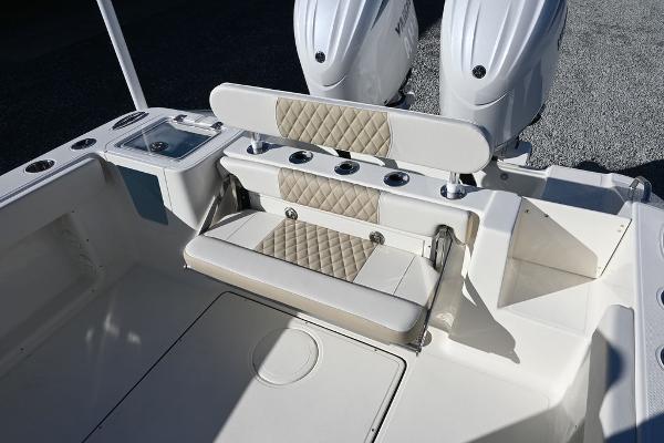 Slide: The Image of 2025 Bulls Bay 255CC boat interior with dual engines and cushioned seating. - 12
