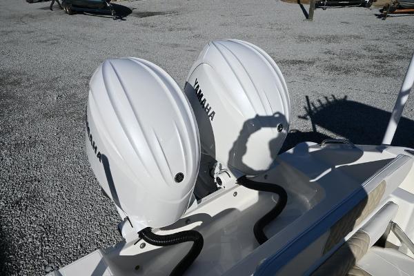 Slide: The Image of Twin Yamaha outboard engines on a 2025 Bulls Bay 255CC boat, parked on gravel. - 16