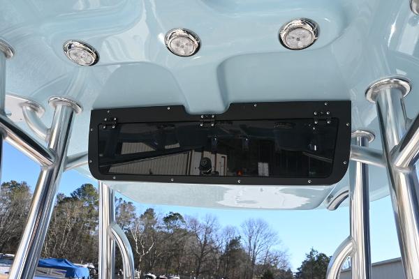 Slide: The Image of Bulls Bay 255CC 2025 boat T-top with built-in lights and storage compartment. - 17
