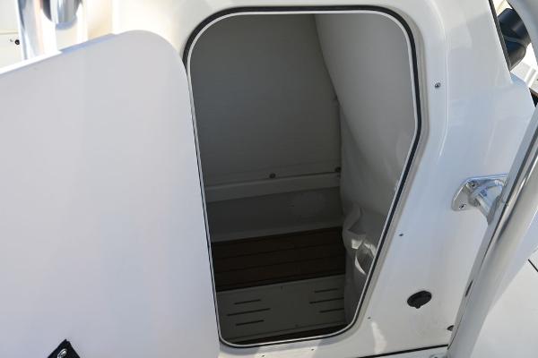 Slide: The Image of 2025 Bulls Bay 255CC boat interior cabin with open door, showcasing sleek design. - 19