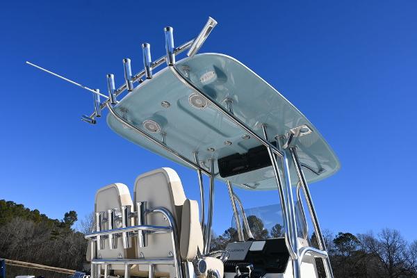Slide: The Image of 2025 Bulls Bay 255CC boat with T-top and rod holders against clear blue sky. - 2