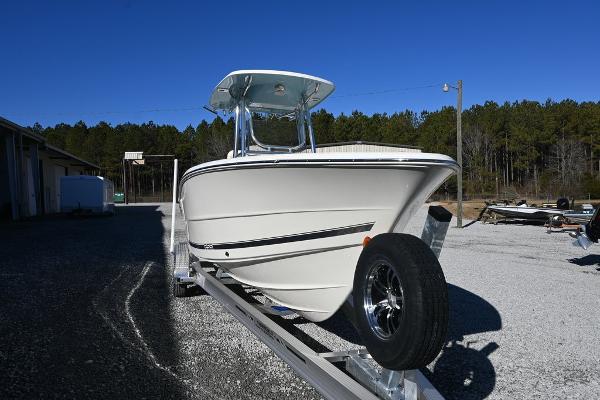 Slide: The Image of 2025 Bulls Bay 255CC boat on trailer, parked outdoors under clear blue sky. - 5