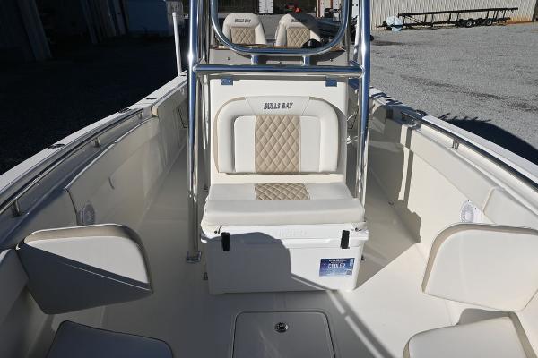 Slide: The Image of 2025 Bulls Bay 255CC boat interior with cushioned seating and center console. - 8