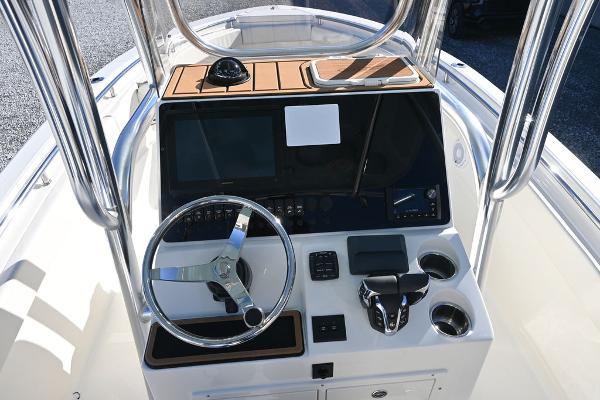 Slide: The Image of 2025 Bulls Bay 255CC boat console with steering wheel and controls. - 9