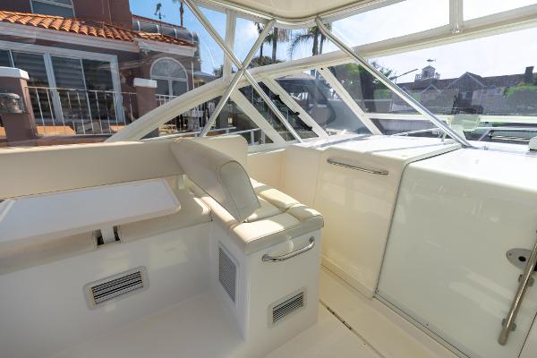 Slide: The Image of 2013 Cabo 36 Express boat interior with white seating and windows. - 21