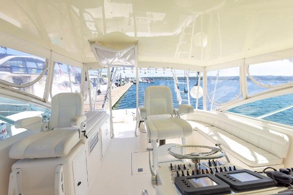 Slide: The Image of Interior view of 2005 Cabo 40 Express yacht with helm and seating. - 16