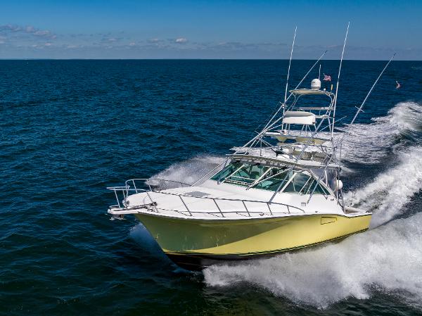 Slide: The Image of 2005 Cabo 40 Express yacht cruising on open water. - 2