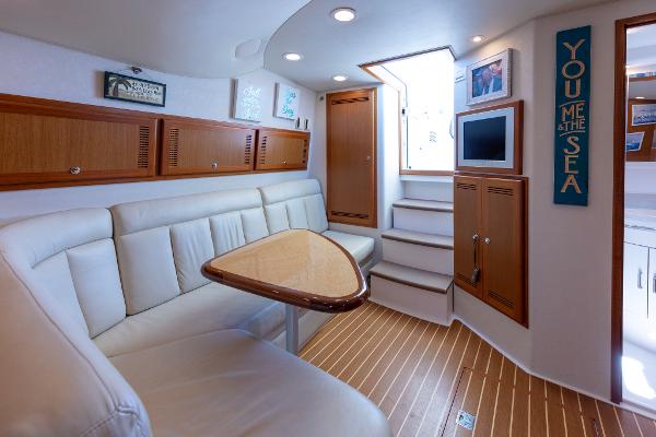 Slide: The Image of Interior of 2005 Cabo 40 Express yacht with elegant seating and wooden accents. - 23