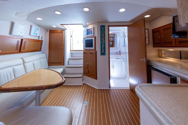 Slide: The Image of Interior of 2005 Cabo 40 Express yacht with modern amenities and wood flooring. - 24