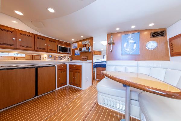 Slide: The Image of Luxurious interior of a 2005 Cabo 40 Express yacht with modern kitchen and seating area. - 27